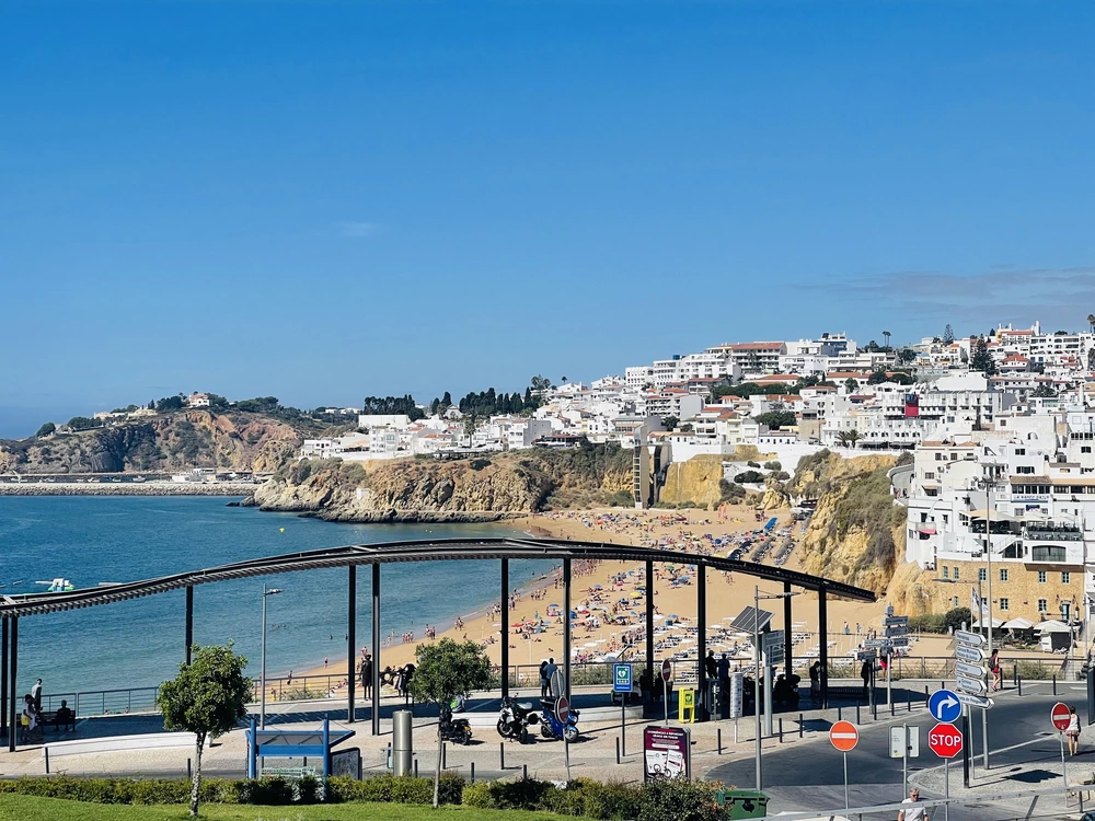 Panoramic view from the Miradouro do Pau da Bandeira lookout point, showing the beautiful sandy beach and the whitewashed buildings of Old Town Albufeira.