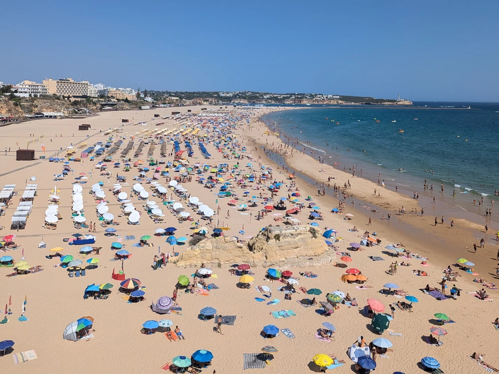 Praia Da Rocha Beach full of sunbathers in peak summer