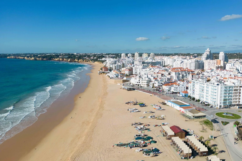Aerial view of Praia de Armação de Pêra beach and the seafront buildings, Algarve
