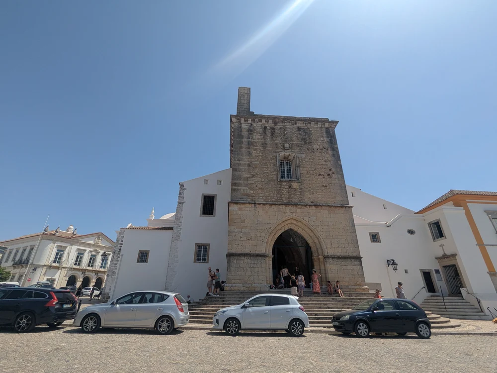 The historic Sé de Faro (Faro Cathedral) with its imposing stone bell tower, as seen from the Largo da Sé.